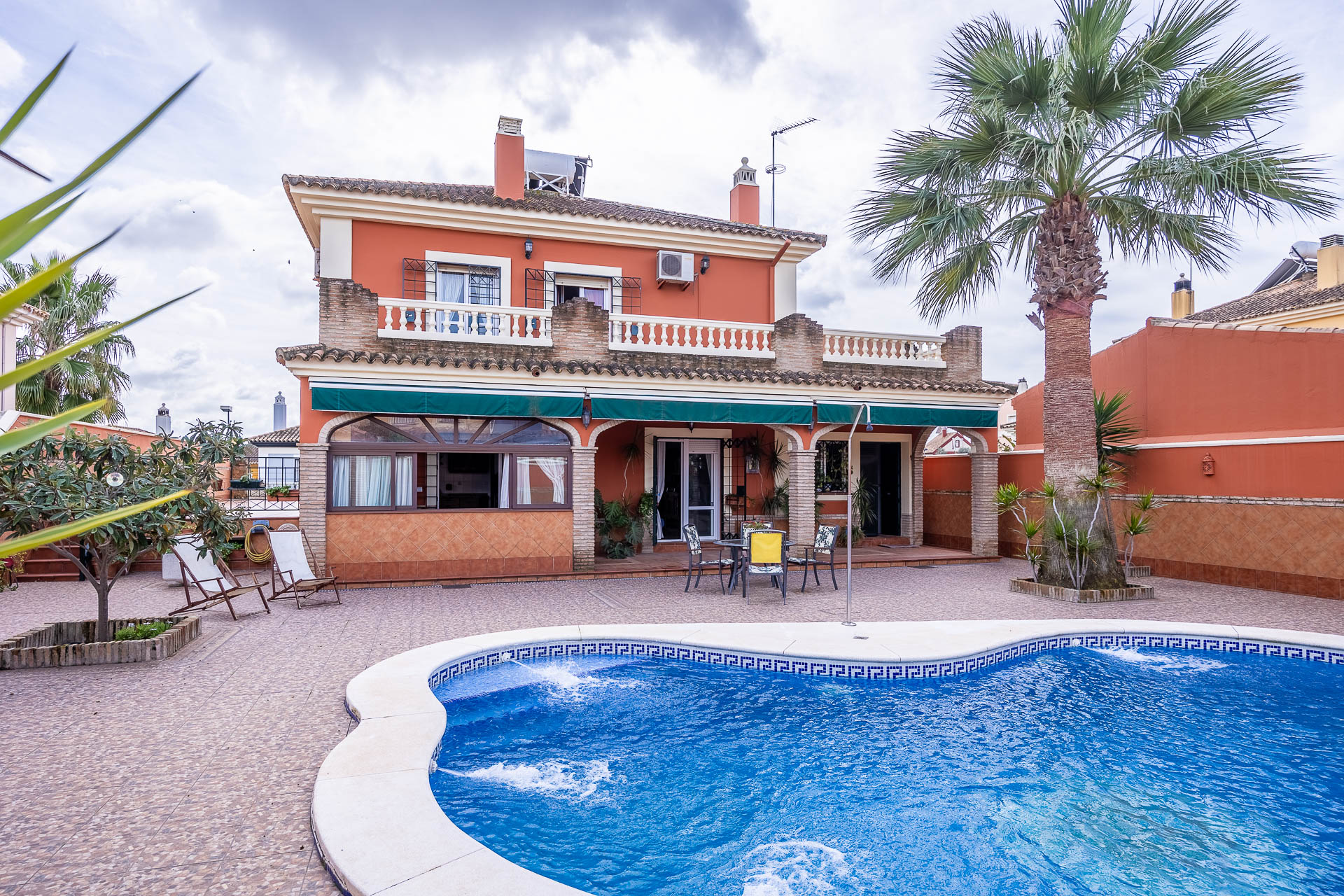 Two-story house with pool.