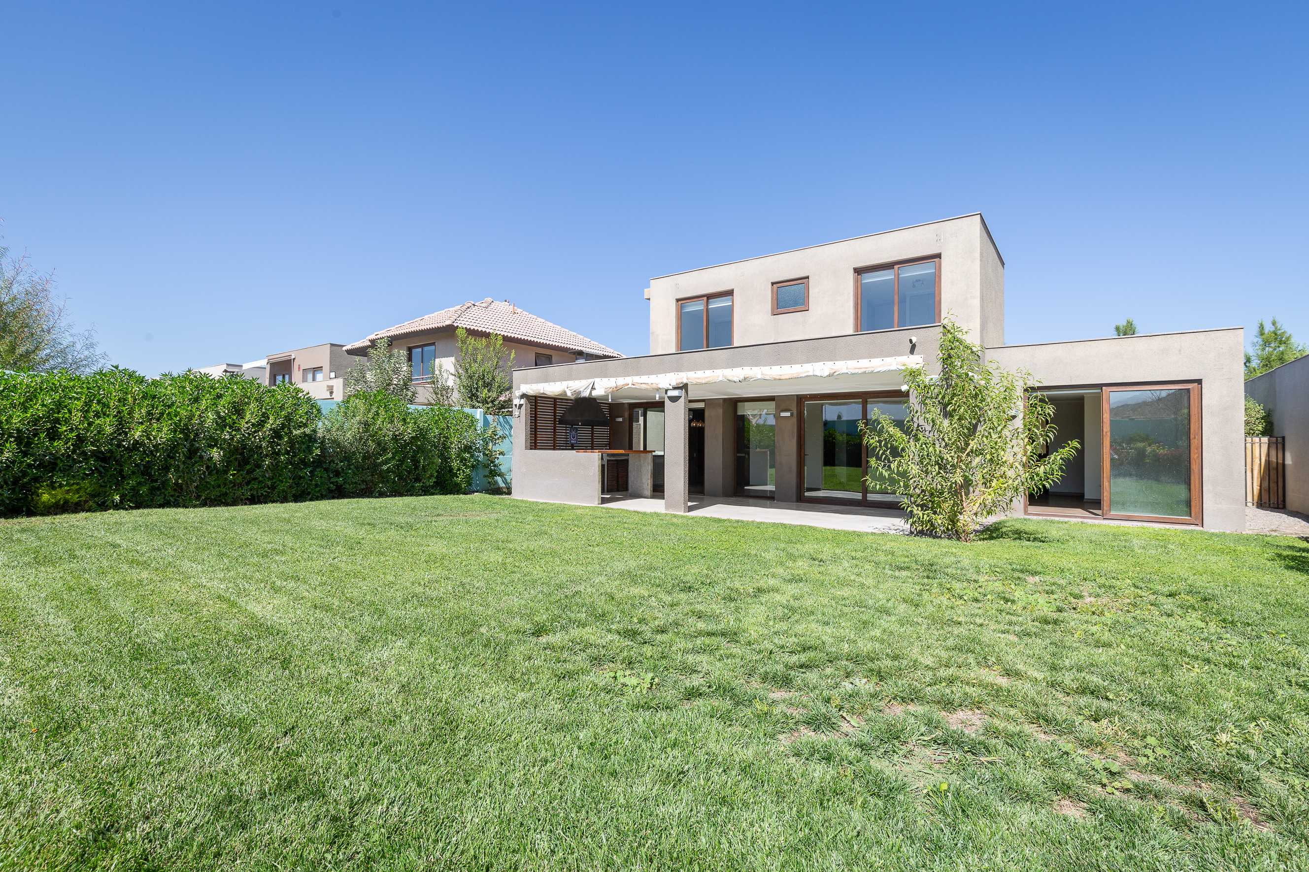 Mediterranean-style house with a terrace featuring an integrated barbecue area.