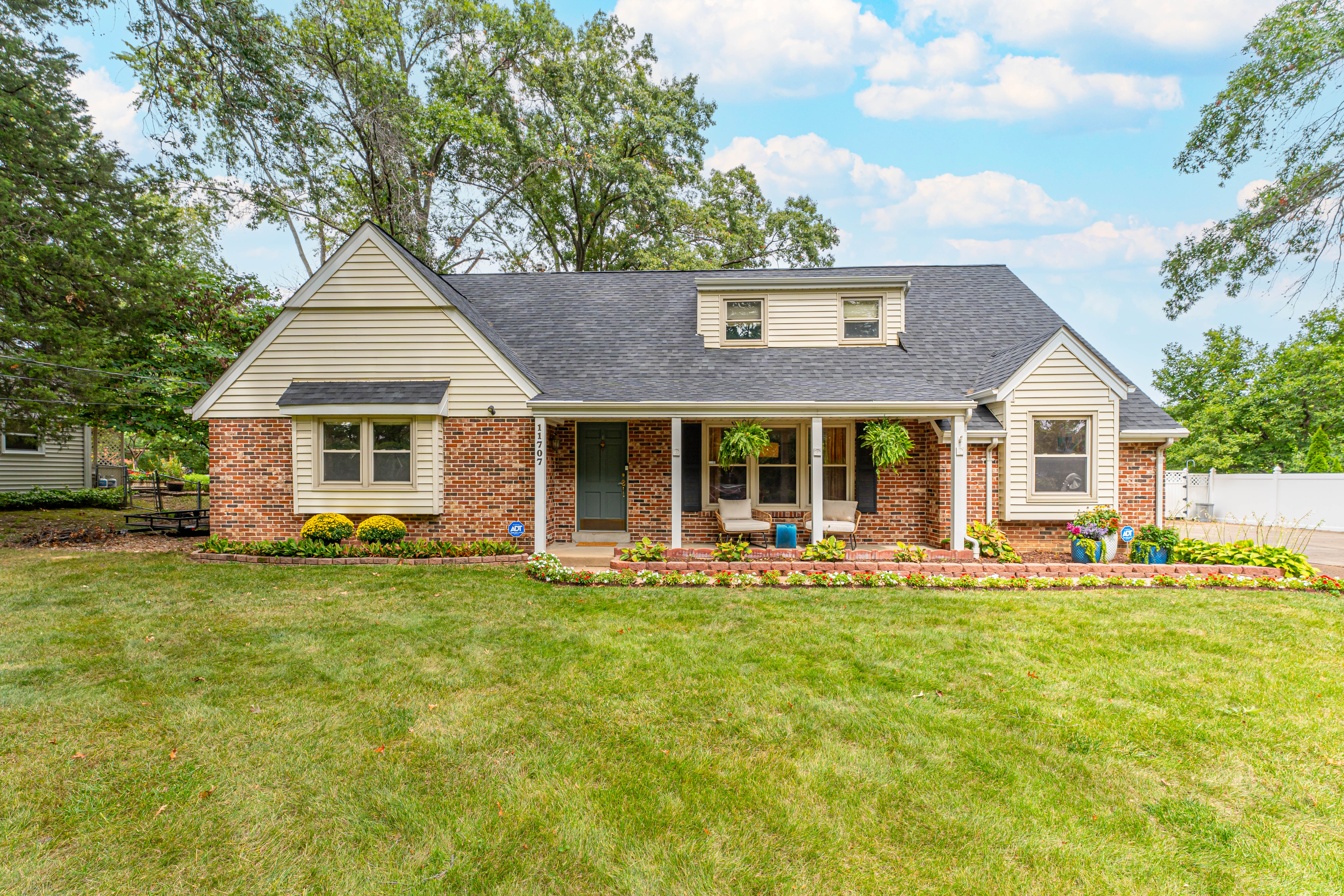 Charming Cape Cod nestled on over a 1/2 acre of beautiful park-like grounds